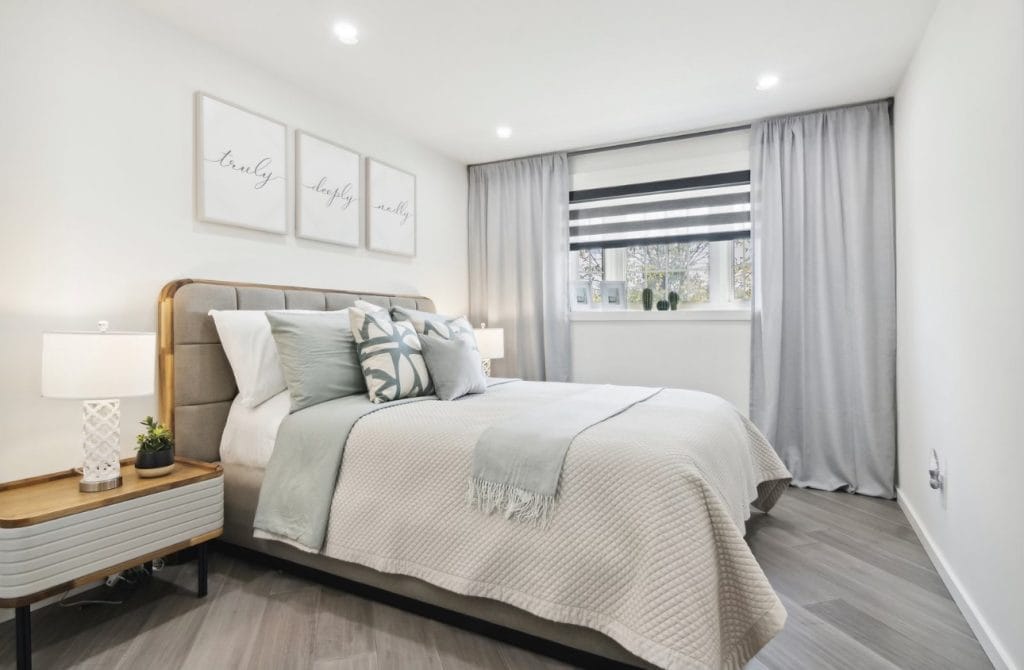 Elegant Master Bedroom Staging in a Tiny Aurora Semi Beautifully staged master bedroom in a tiny semi-detached house in Aurora, featuring coordinated bedding, accessories, curtains, lamps, and artwork.