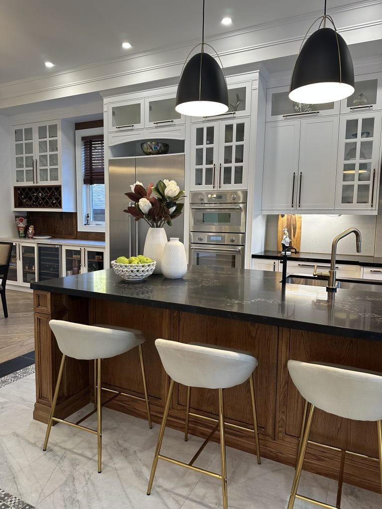 Elegant Staged Kitchen Island with Bar Stools and Coordinated Decor Staged kitchen island with bar stools, decorative accents, and a design matching the interior.
